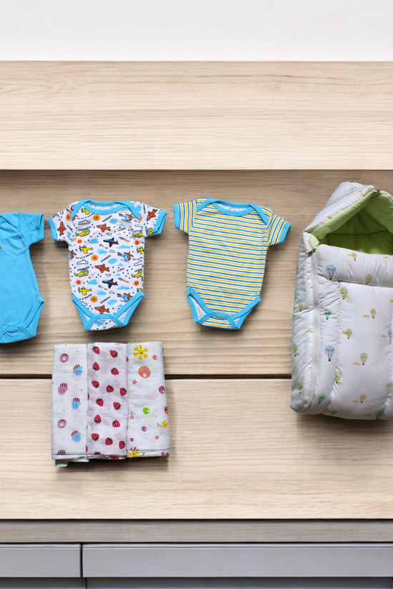 Organic Cotton Onesies & Muslin Swaddles With White Sleeping Bag